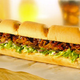 Illustration for article titled Fast-Food Fight: Subways Pulled Pork Vs. Wendys Pretzel Bacon Burger